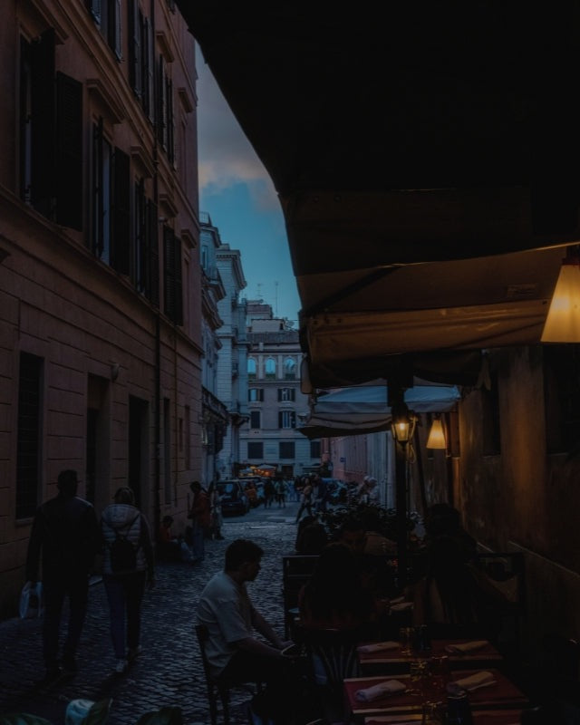 A lantern-lit European laneway at dusk