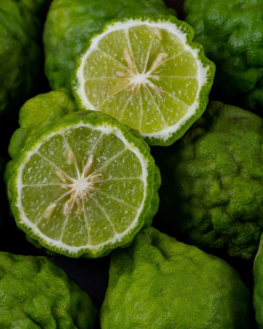Halved green bergamot citrus showing its pale flesh