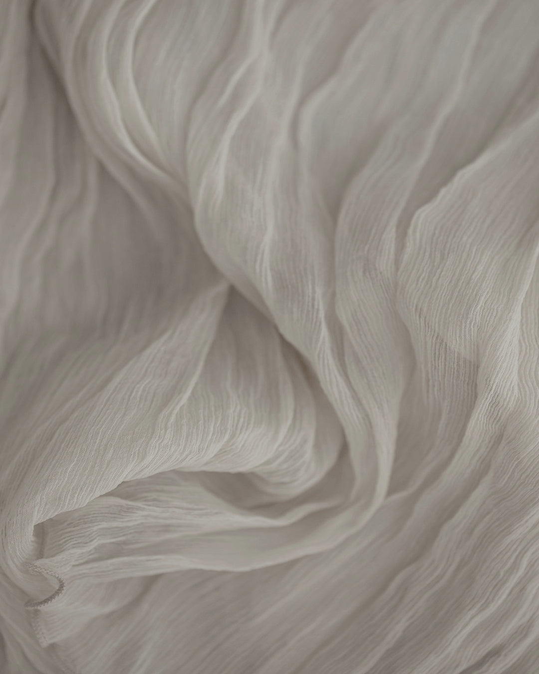 Soft folds of ivory cashmere fabric