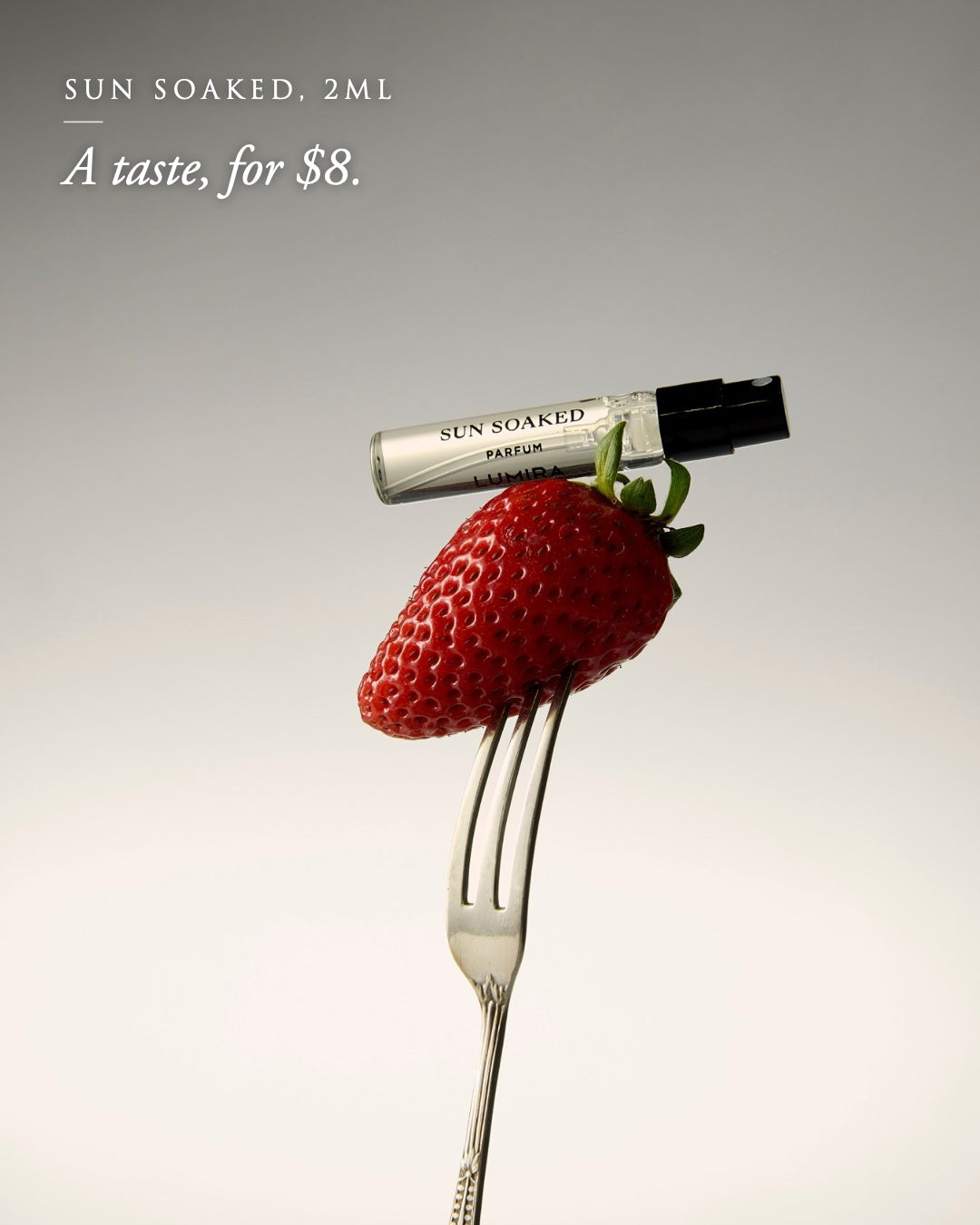 Sun Soaked 2ml sample resting on a strawberry on a silver fork